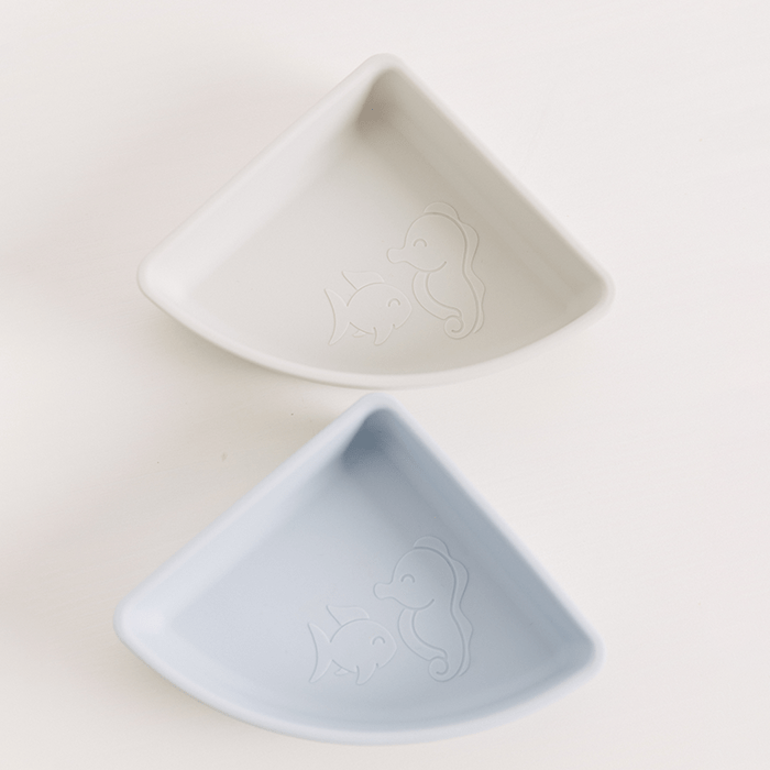 Baby by Beach tableware set, featuring a close up of the individual divider snack bowl with two cute characters, Frida the Fish and Sarie the Seahorse.